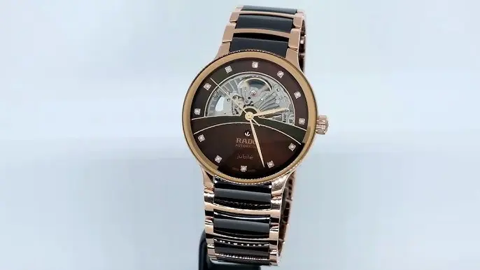 R-60283090 | R30028902 | ראדו יבואן רשמי בישראל | דגם סנטריקס סקלטון לגברים | אוטומטי עם 12 יהלומים בלוח פנינה חום | רוז גולד עם קרמיקה חומה | Centrix Automatic Diamonds Open Heart RADO R30028902